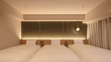 A hotel room with two beds, a large wall panel, a hanging light fixture, and a curtain.
