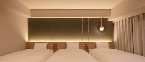 A hotel room with two beds, a large wall panel, a hanging light fixture, and a curtain.