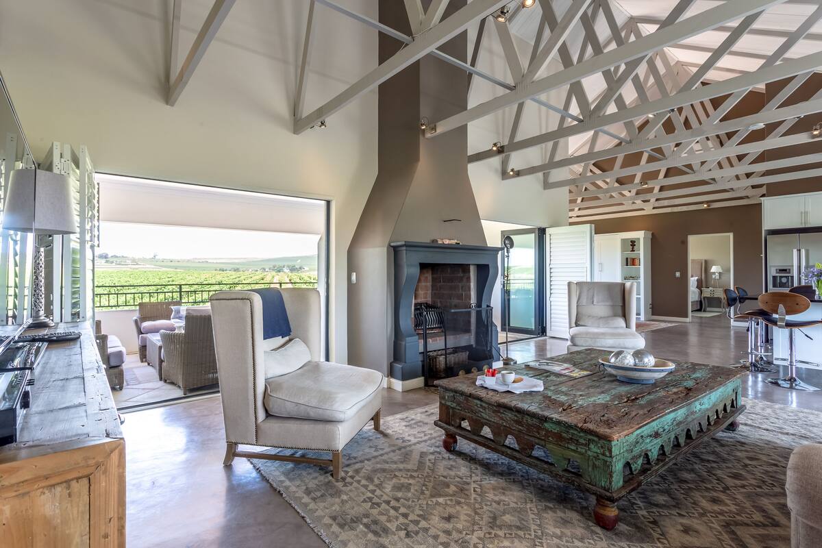 A spacious living area with a fireplace, comfortable seating, and a view of the outdoors.
