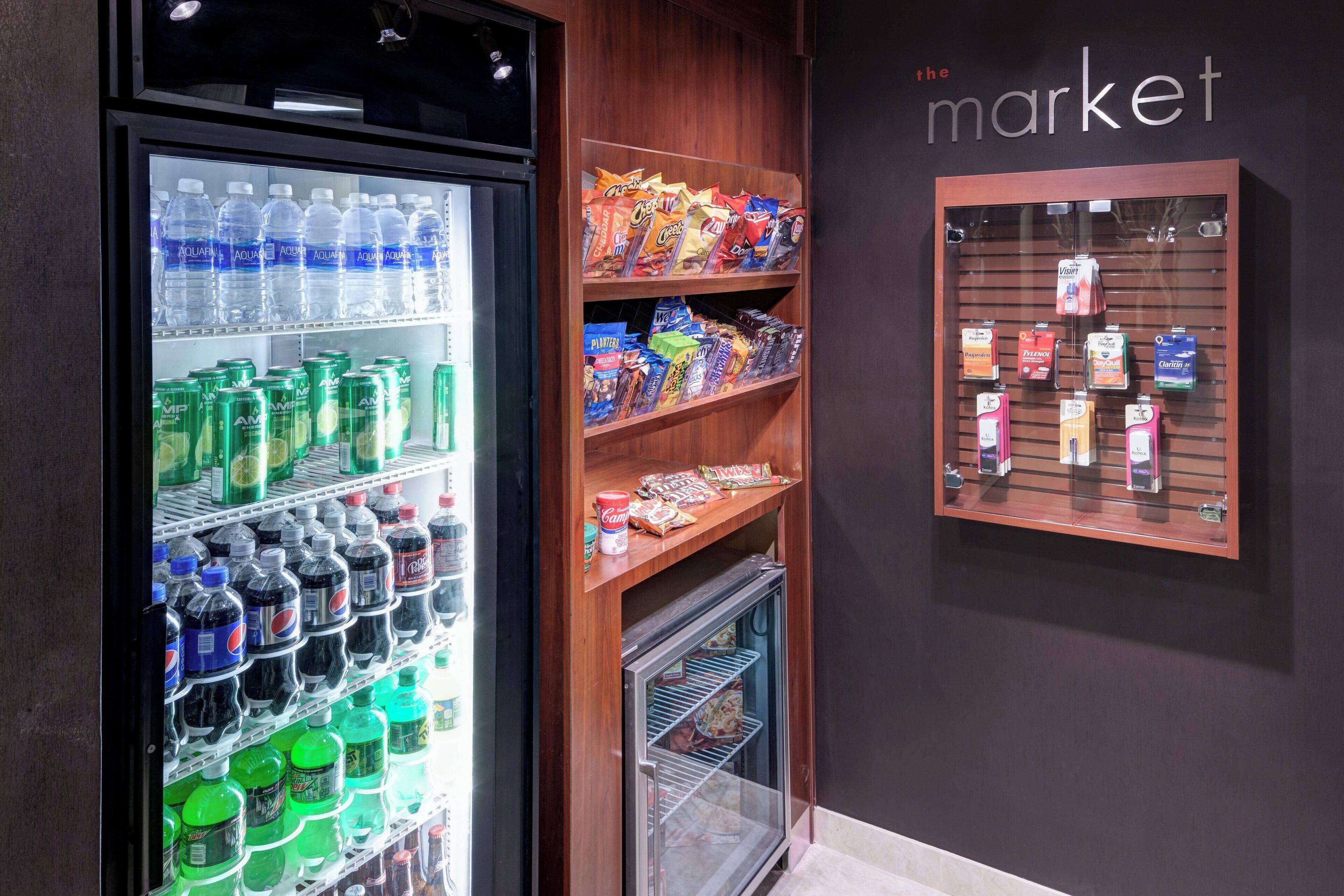 A refrigerated display case with various beverages and snacks.