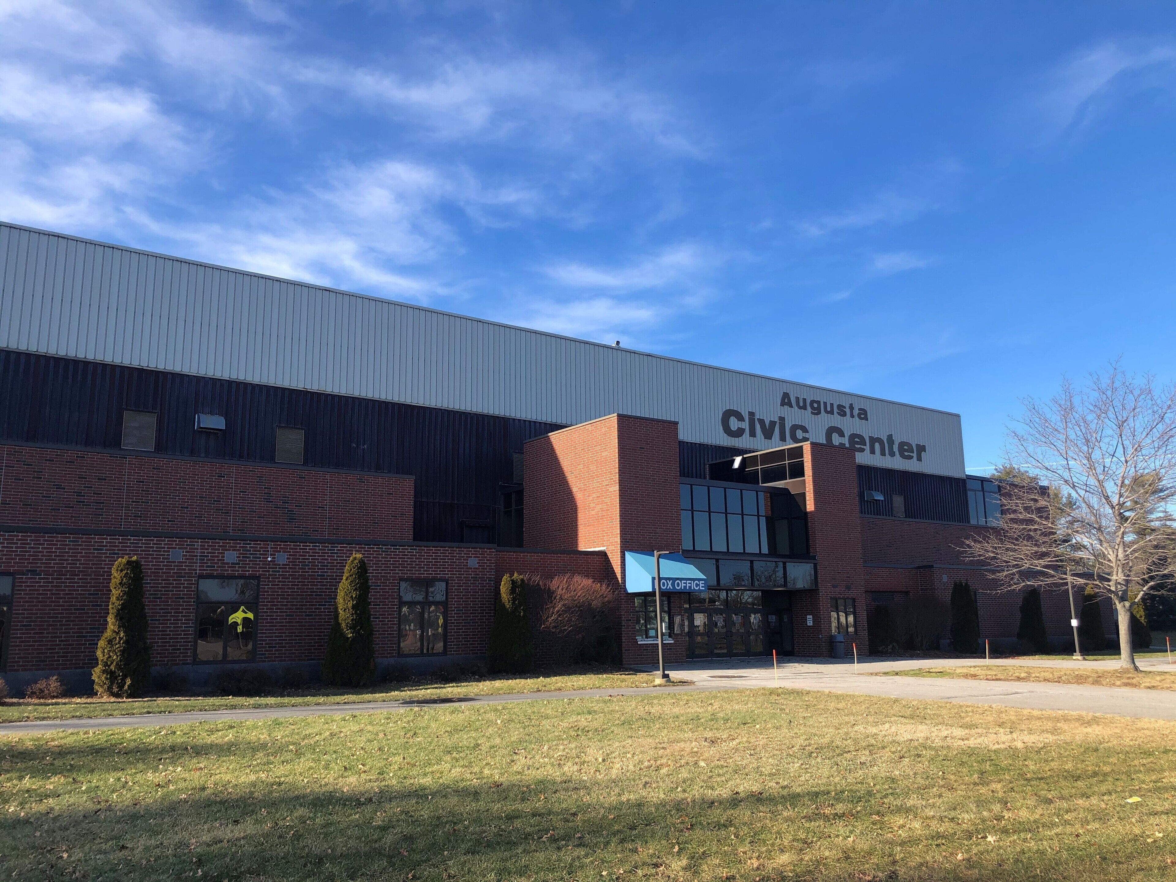 Augusta Civic Center with a modern brick facade, large windows, and a clear sky.