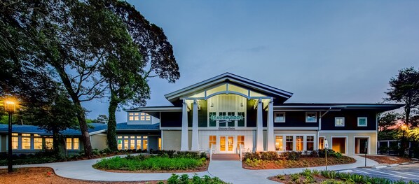 A two-story building with a 'Welcome Center' sign, large windows, and a well-lit entrance. - Hilton Vacation Club Beachwoods Kitty Hawk (Kitty Hawk)
