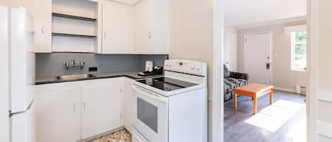 A modern kitchen with white cabinets, a built-in oven, and a countertop.
