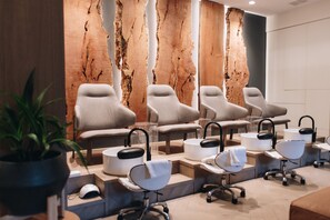 A modern spa with multiple seating areas and a large wooden wall feature. - Nita Lake Lodge (Whistler)