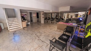 A spacious indoor area with a marble floor, multiple seating areas, and a visible staircase leading to another level. - Begonville Hotel (Marmaris)