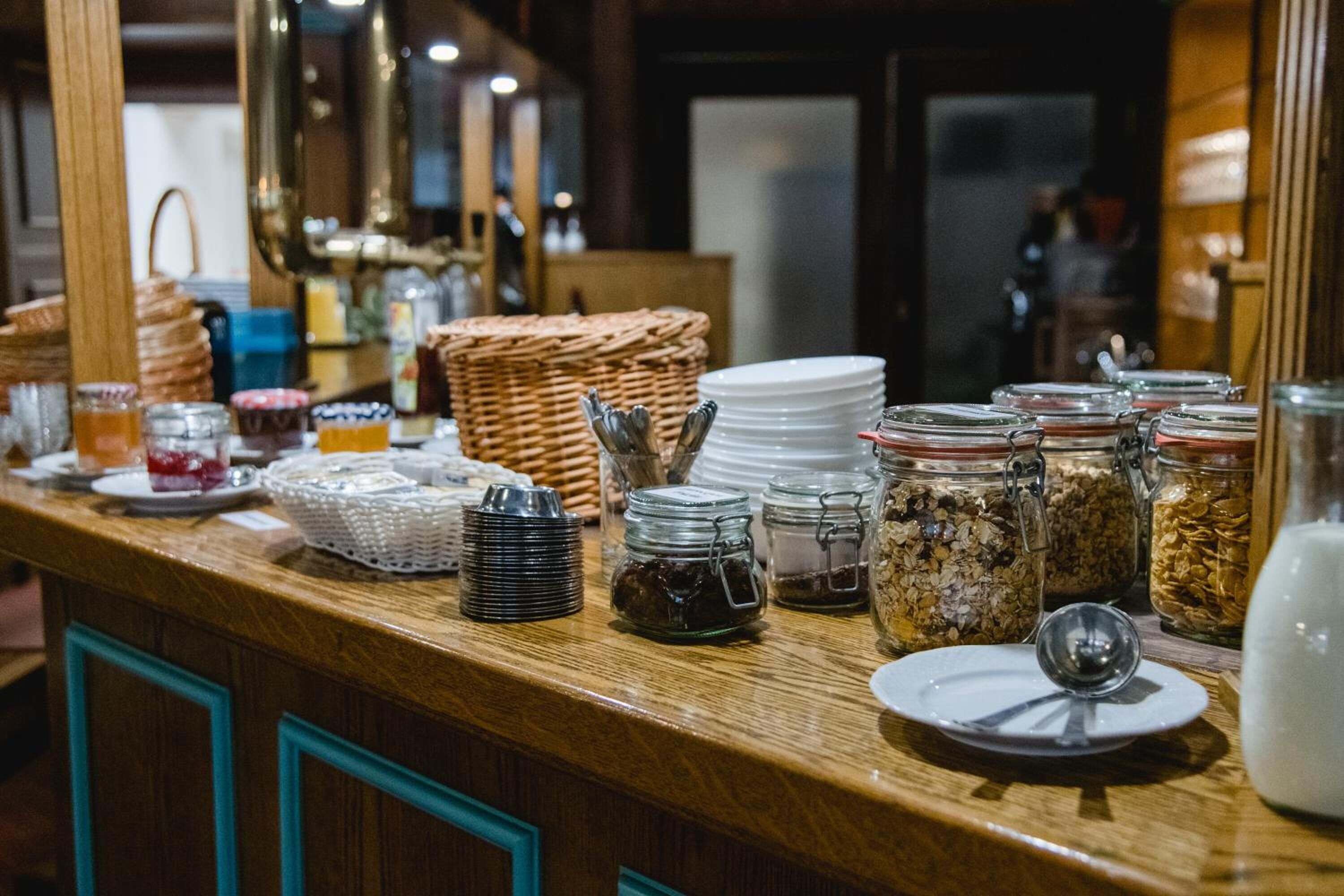 A buffet counter with various food items and utensils.