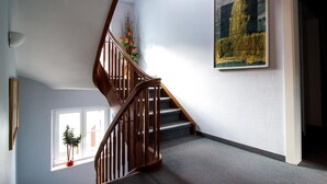 A staircase with wooden railings leading to a landing.