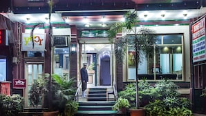A hotel entrance with a staircase, potted plants, and a sign for 'Sunstar Residences'. - Hotel Sunstar Residency (New Delhi)
