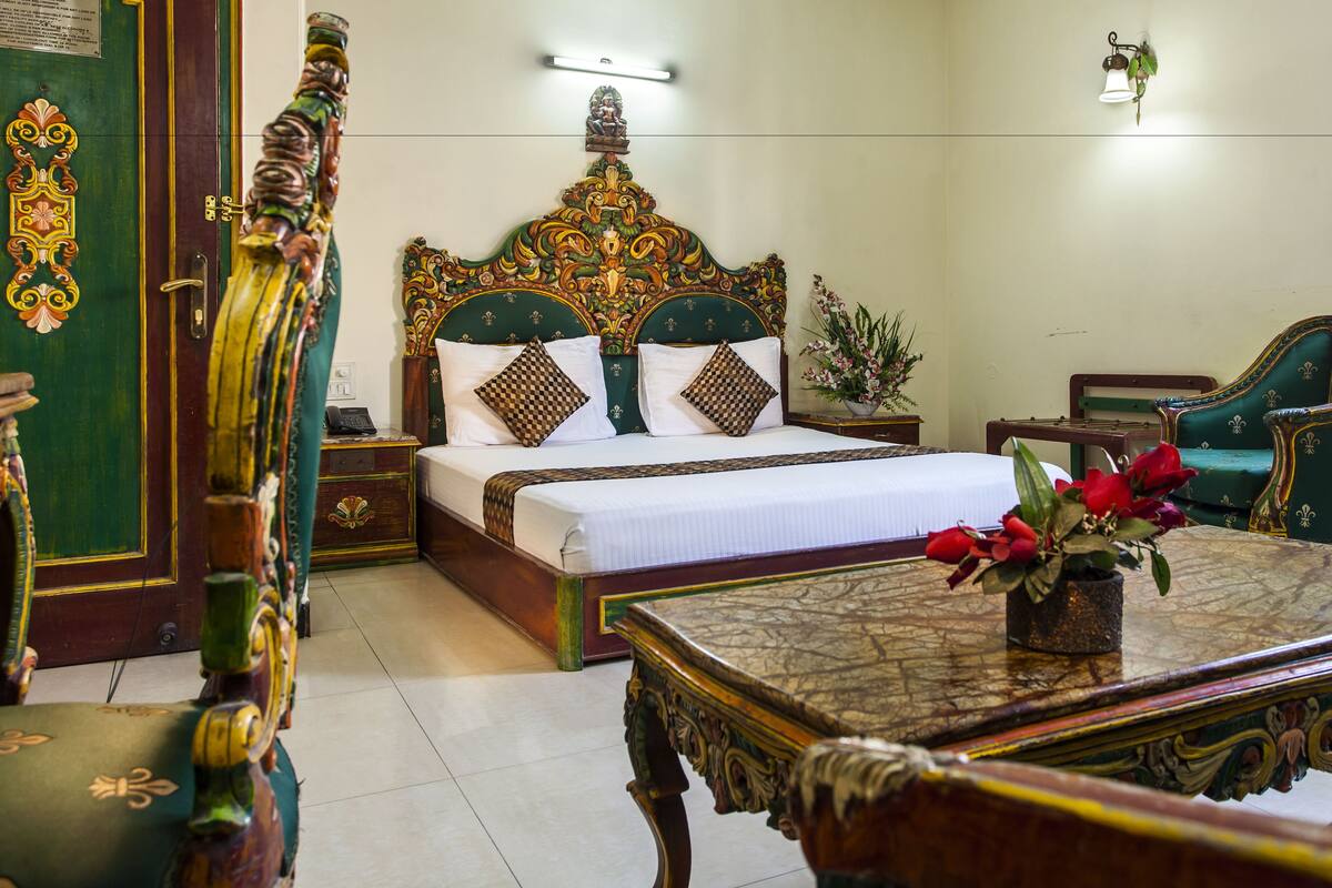 A traditional room with a bed, a table, and a chair.