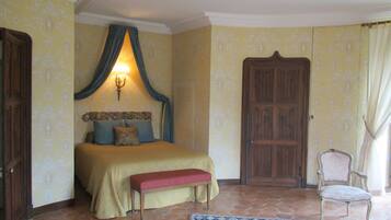 A bedroom with a bed, bench, chair, and a door.