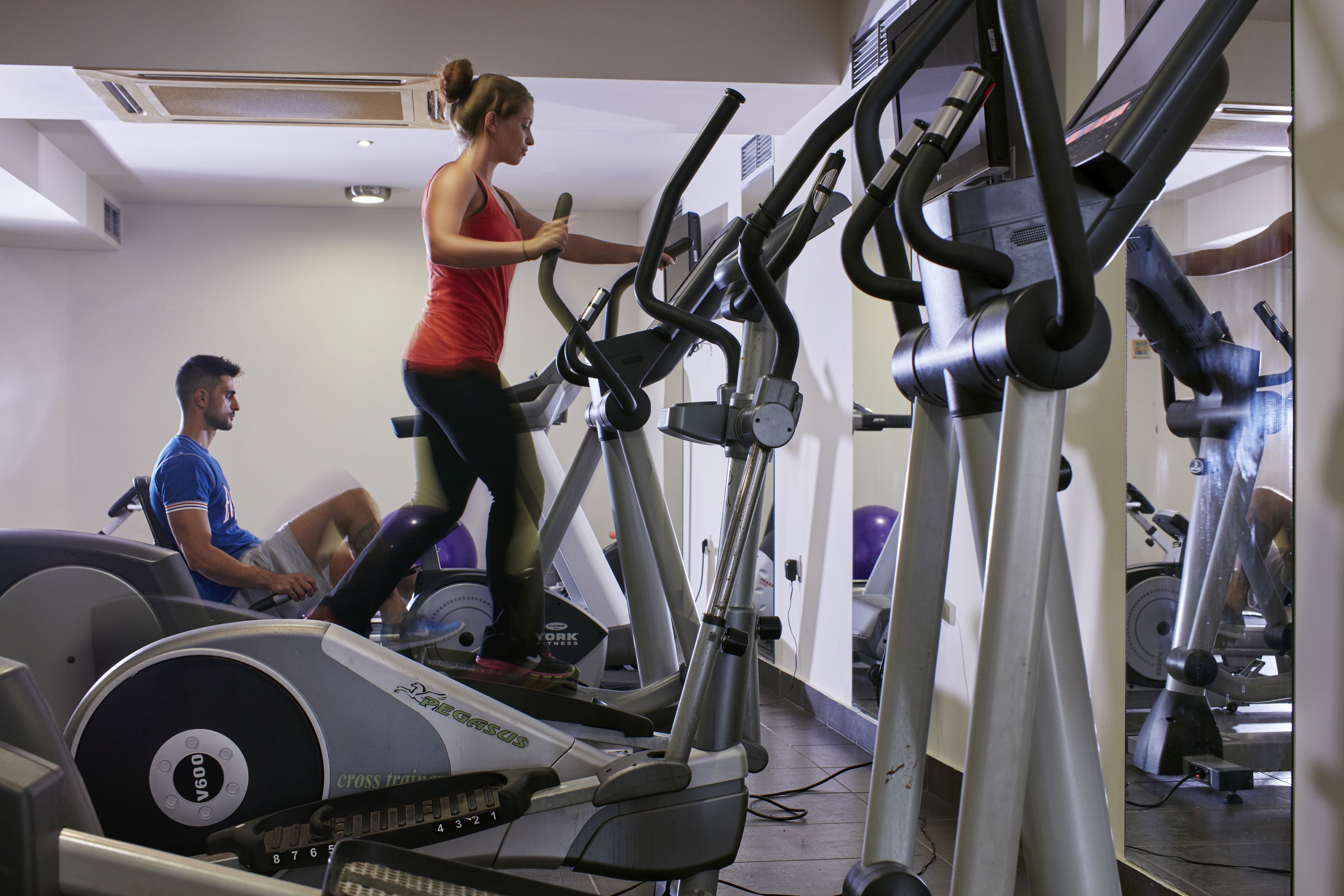 A gym with stationary bikes and treadmills.