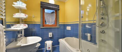 A bathroom with a bathtub, a sink, and a shower.