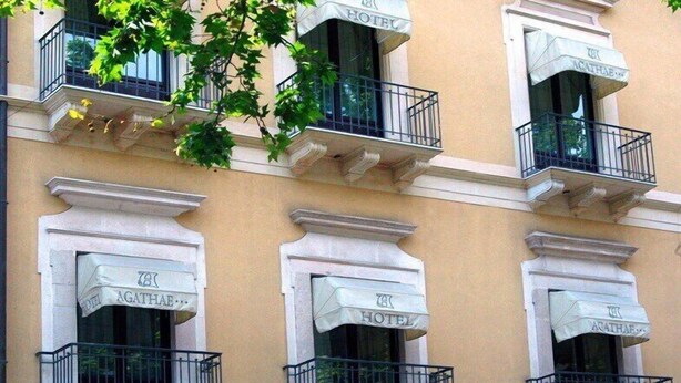 A hotel facade with multiple balconies, each with a white awning labeled "HOTEL AGATHAE." - Hotel Agathae (Catania)
