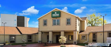 A two-story building with a sign reading 'HomeTowne Studios, Resort'.