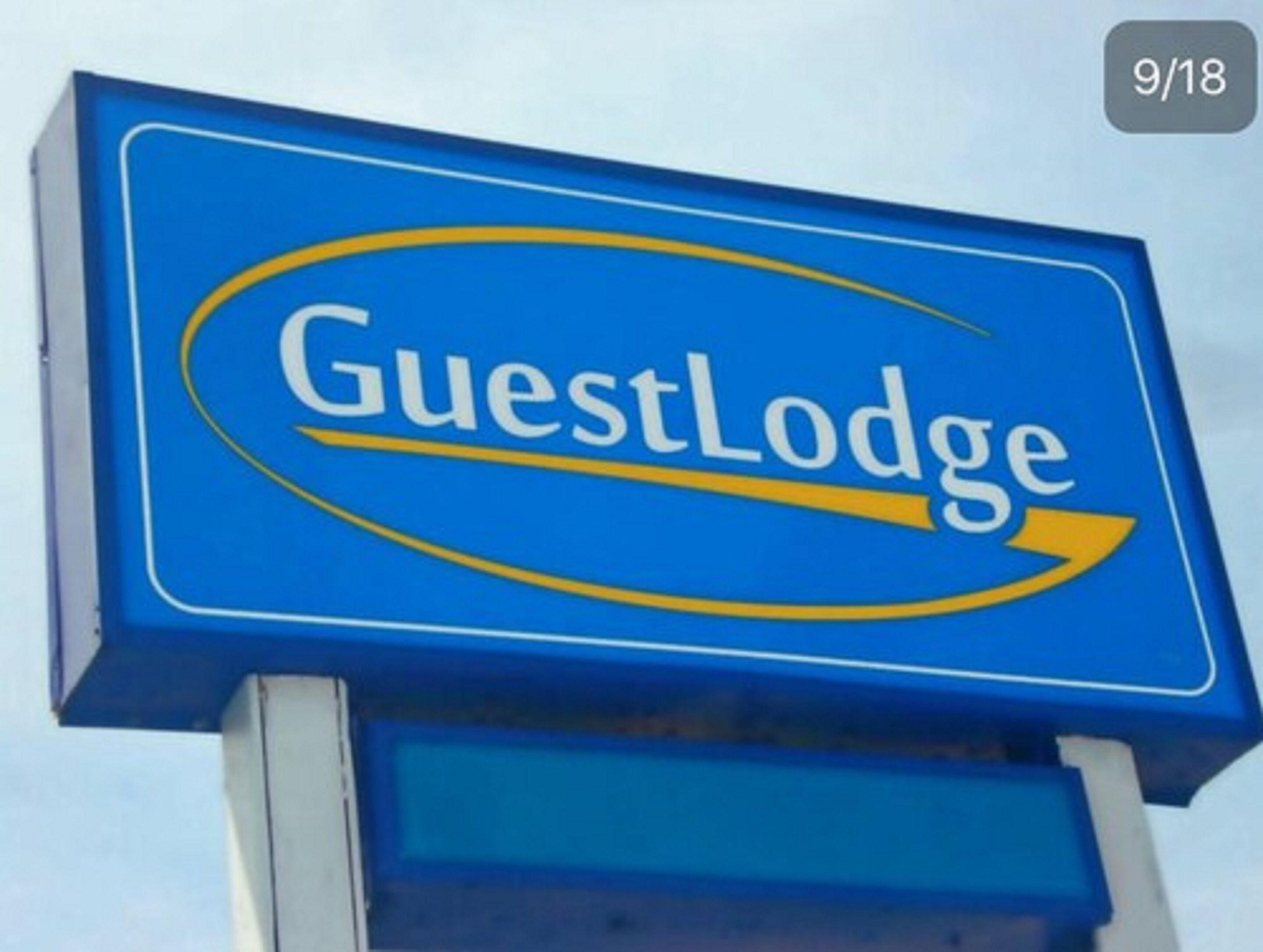A blue sign with the text "GuestLodge" and a yellow swoosh.