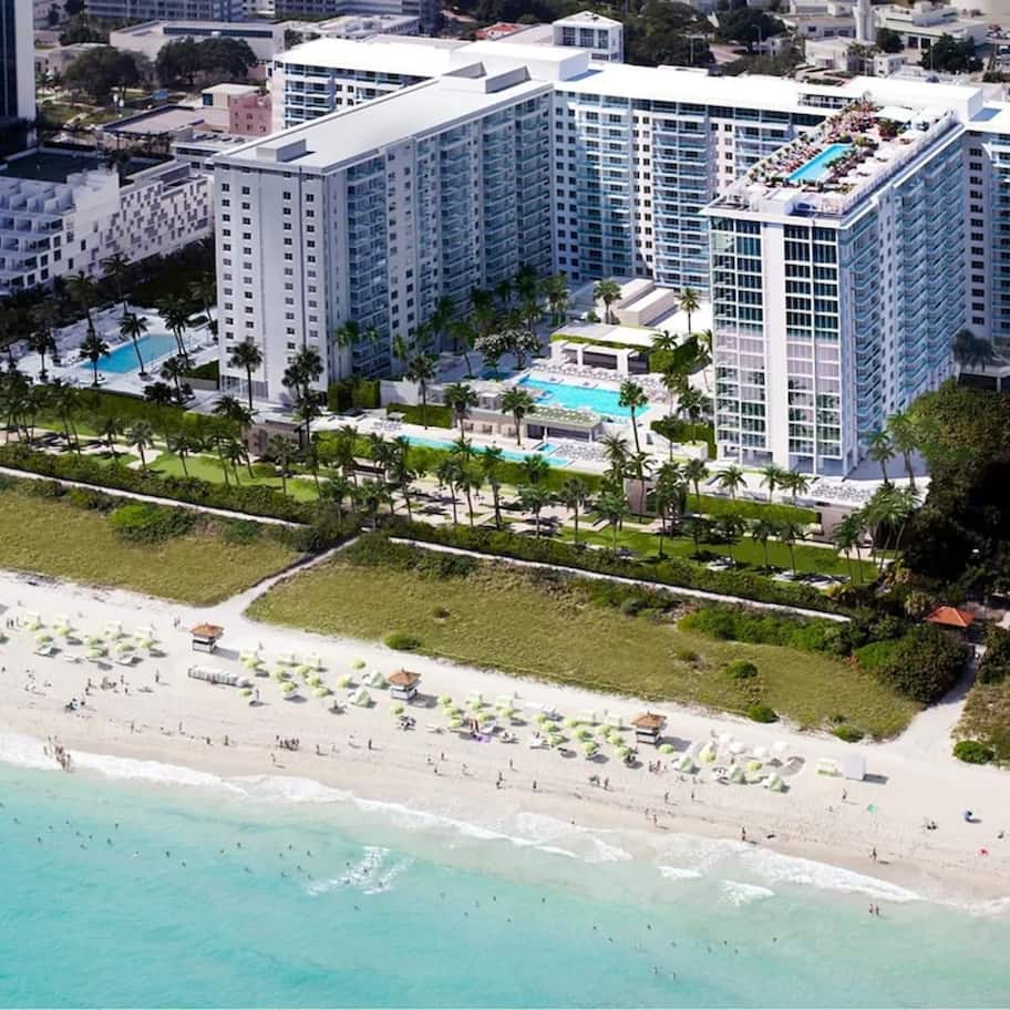 On the beach, white sand, beach cabanas, sun loungers