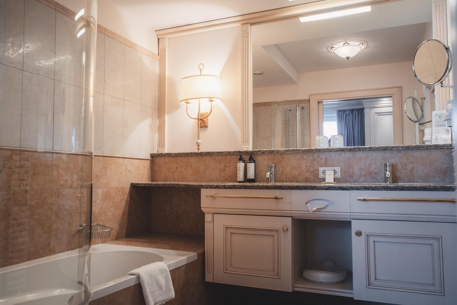 Un baño moderno con bañera, tocador con espejo y zona de ducha.