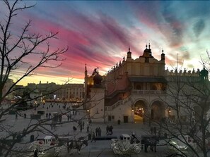 A historic building with multiple domes and a central courtyard with people and horse-drawn carriages. - The Bonerowski Palace Boutique Hotel (Kraków)