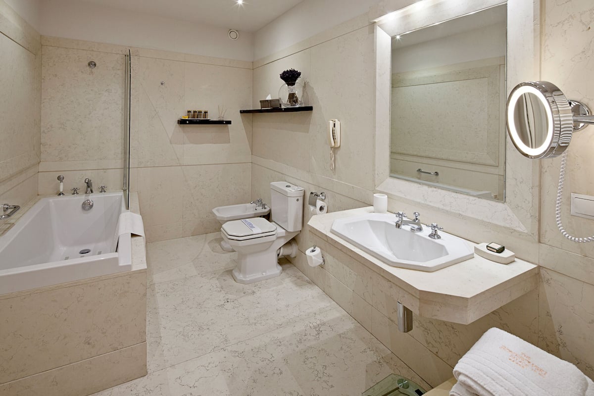 luxury apartment, city view | bathroom | combined shower/bathtub, designer toiletries, hair dryer, bathrobes
