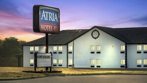 A hotel named 'Atria Hotel-RV' with a sign indicating RV spot availability. - Atria Hotel and RV McGregor (McGregor)