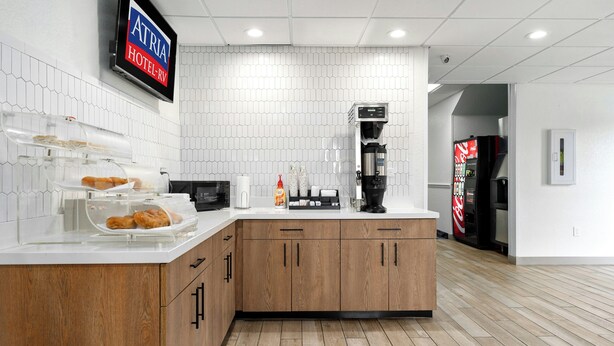 A modern kitchen with a coffee machine, a microwave, and a refrigerator. - Atria Hotel and RV McGregor (McGregor)
