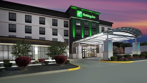 A Holiday Inn hotel with a modern facade, a covered entrance, and landscaped areas with shrubs. - Holiday Inn Quincy East by IHG (Quincy)