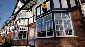 A traditional Tudor-style hotel with a sign indicating it is AA rated. - The Cathedral Hotel (Lichfield)