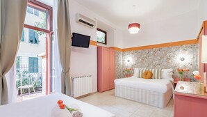 A hotel room with a bed, a desk, a TV, and a window with curtains. - Hotel Espana (Rome)