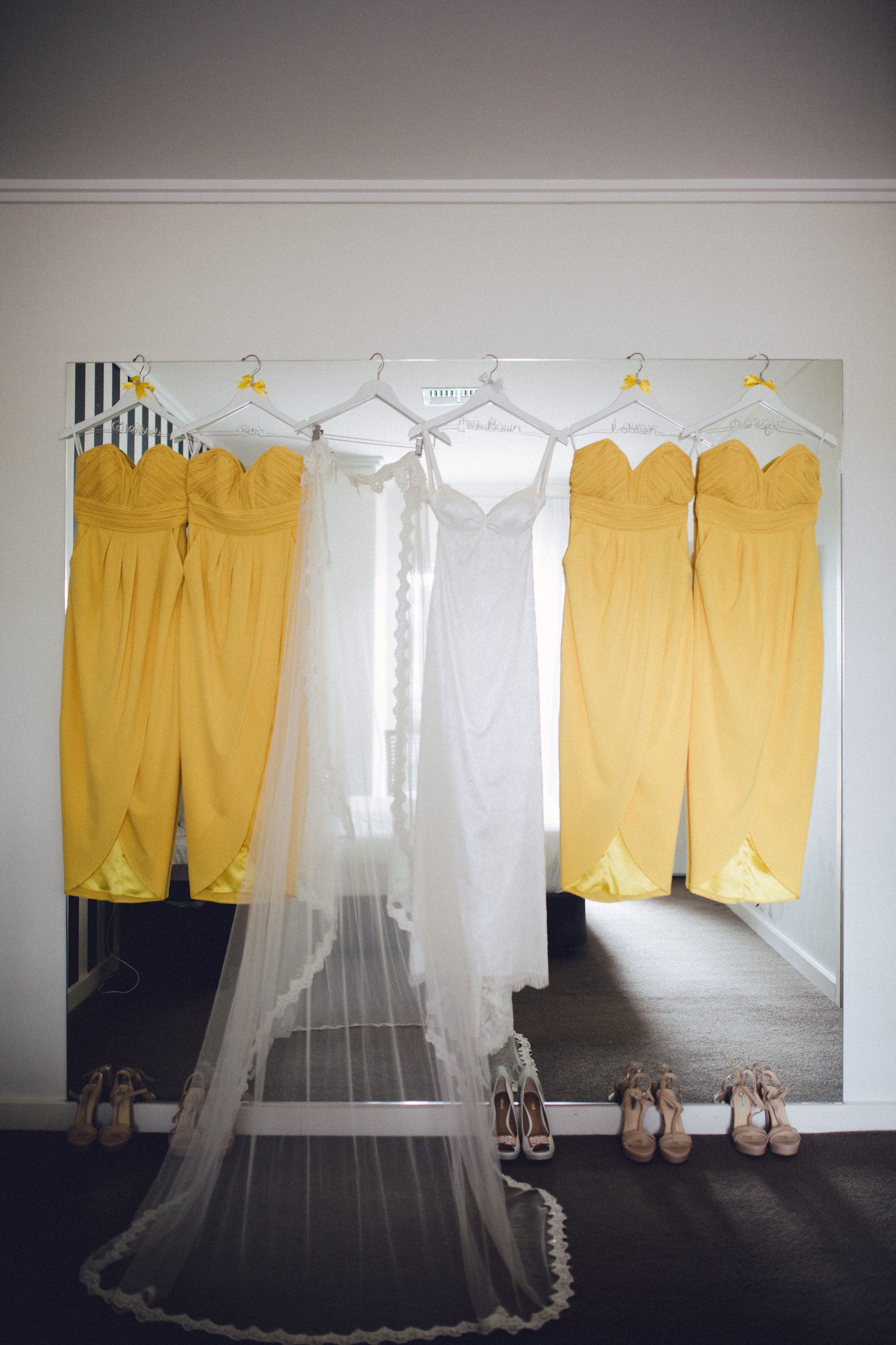 A room with a mirror reflecting yellow pants and a white canopy.