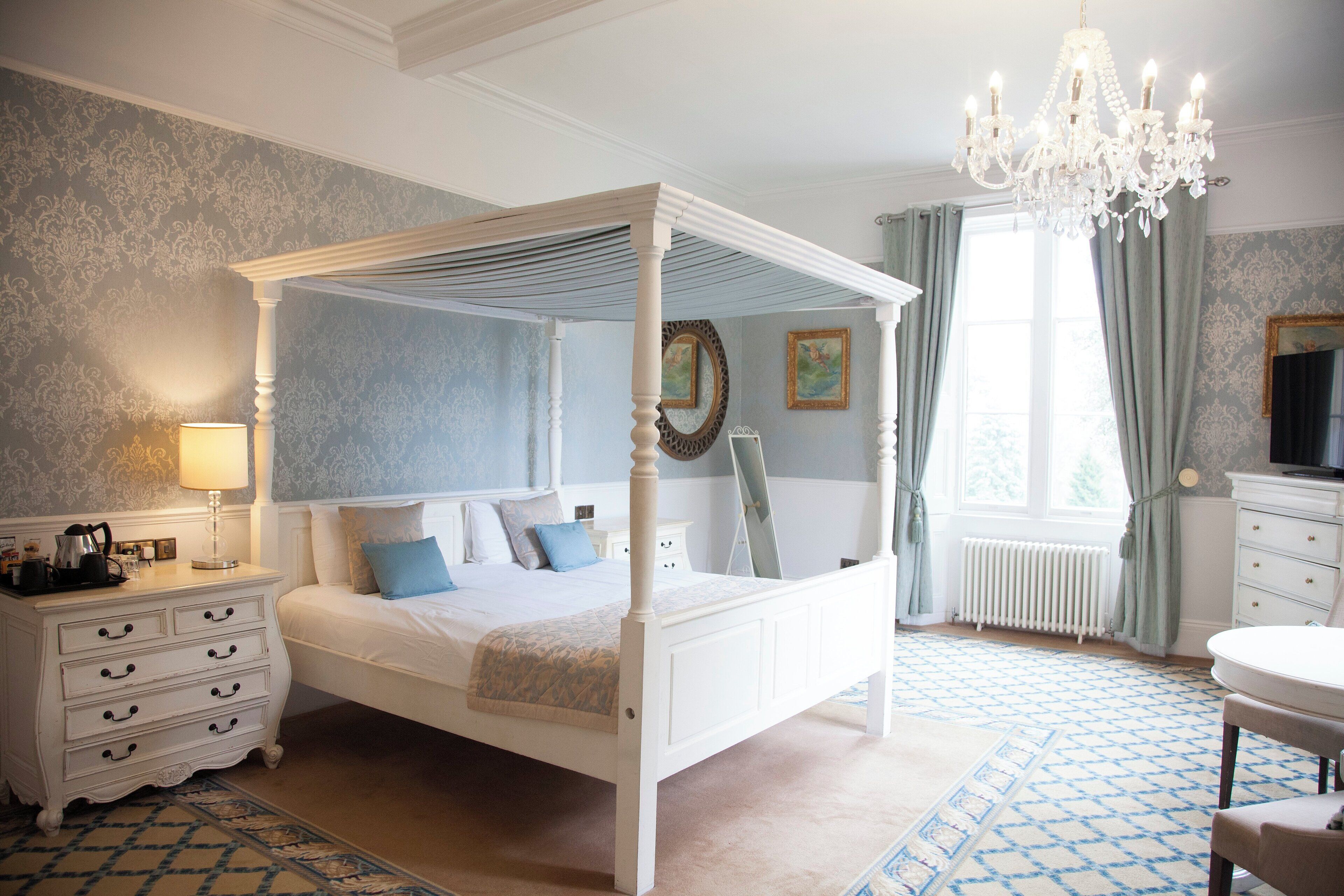 four poster room | in-room safe, individually furnished, desk, iron/ironing board