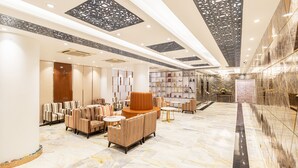 A spacious lobby with a marble floor, striped sofas, and a central seating area. - Dhaka Regency Hotel & Resort (Dhaka)