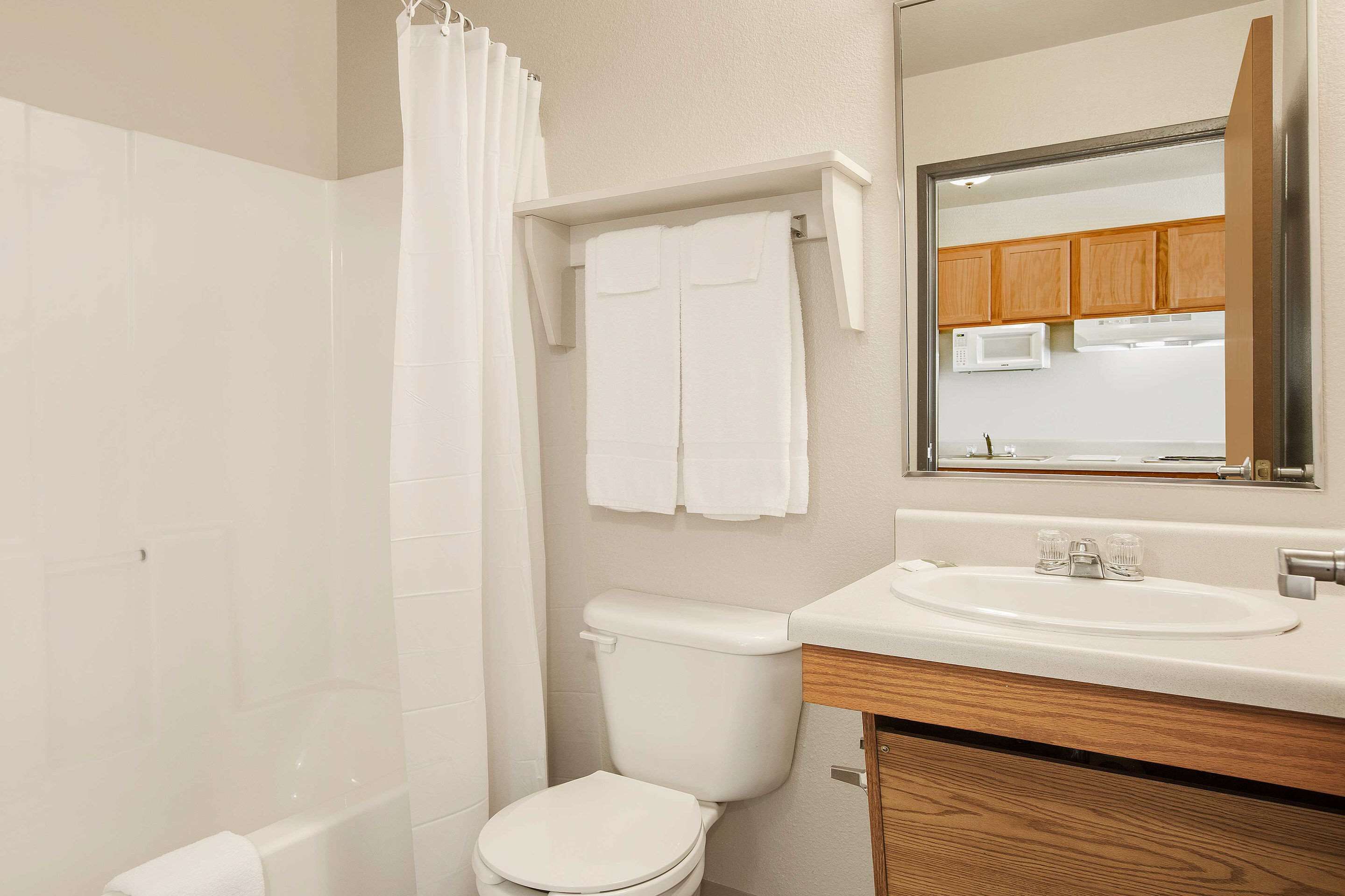 A bathroom with a toilet, a sink, and a shower curtain.