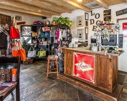 A shop interior with a wooden counter, various items on shelves, and a sign reading 'Superior'.