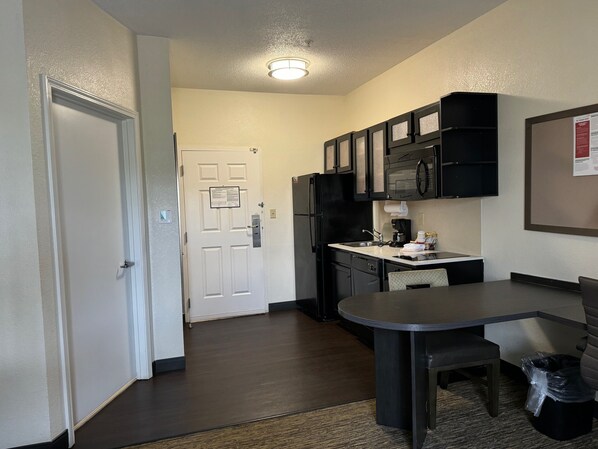 A compact kitchen with a refrigerator, microwave, and coffee maker. - Candlewood Suites Olive Branch by IHG (Olive Branch)