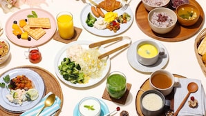 A table set with various dishes, including waffles, fruit, and soup, suggesting a breakfast or brunch setting. - Comfort Hotel Tomakomai (Tomakomai)