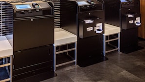 A row of self-service kiosks with card readers and a digital display, likely for check-in or payment. - Comfort Hotel Tomakomai (Tomakomai)