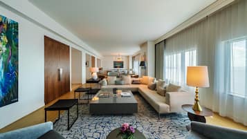 A spacious living area with a sofa, coffee table, and a dining table.