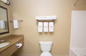 A bathroom with a sink, toilet, and a towel rack with multiple towels. - Country Inn & Suites by Radisson, Grand Forks, ND (Grand Forks)