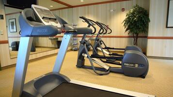 A hotel fitness room with a treadmill, elliptical, and stationary bike.