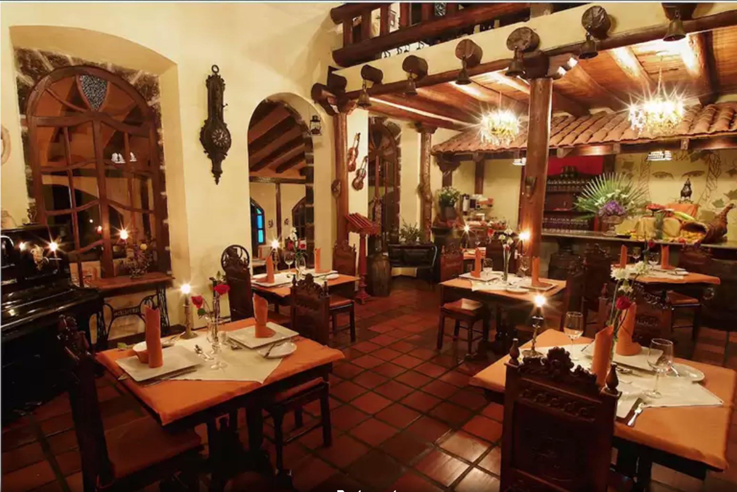 A restaurant with wooden tables, chairs, and a tiled floor.