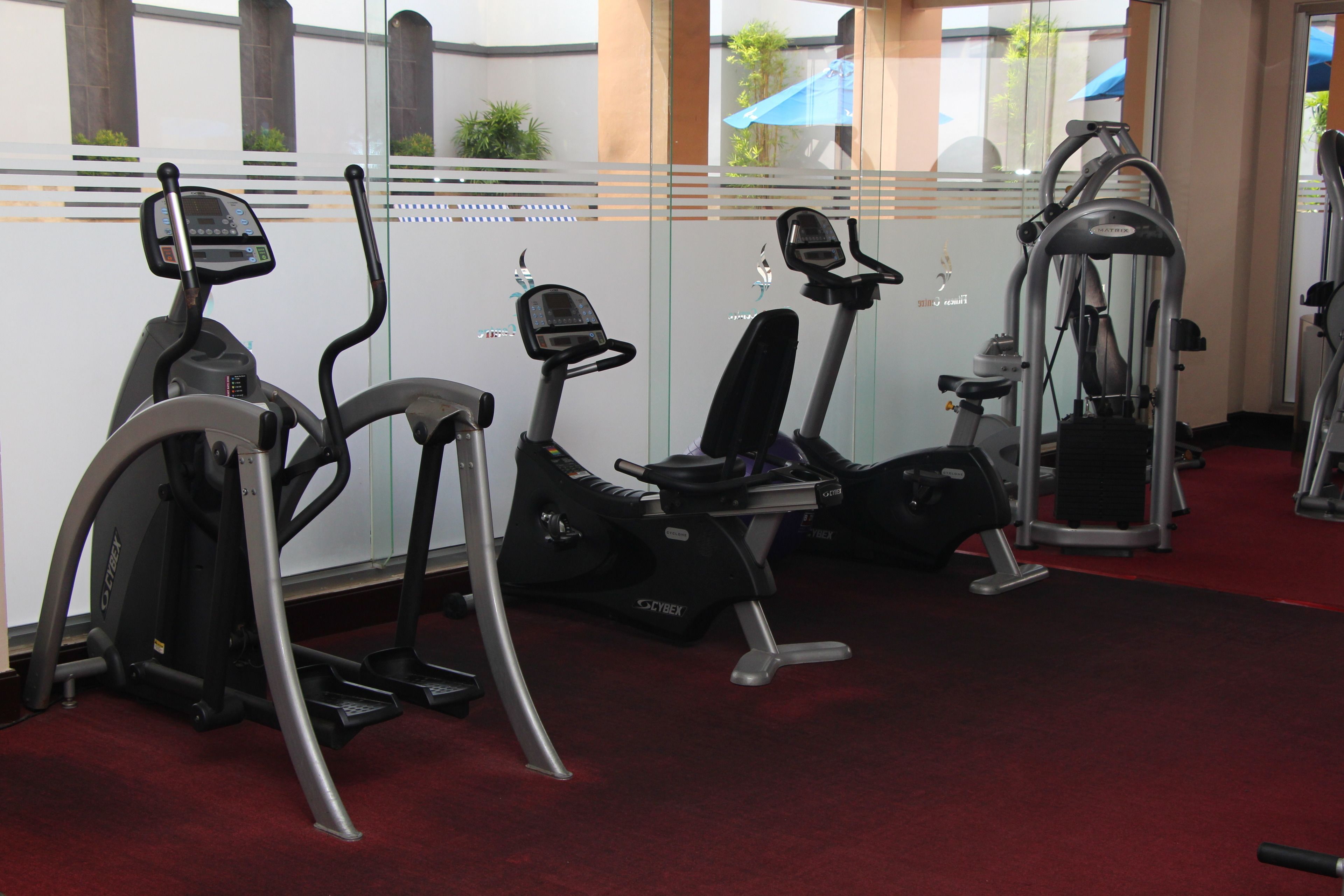 A gym with treadmills, an elliptical, and a weight machine.