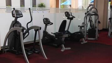 A gym with treadmills, an elliptical, and a weight machine.