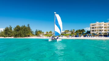 On the beach, white sand, sun-loungers, beach umbrellas