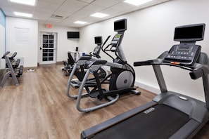A fitness center with treadmills, elliptical machines, and weight machines.