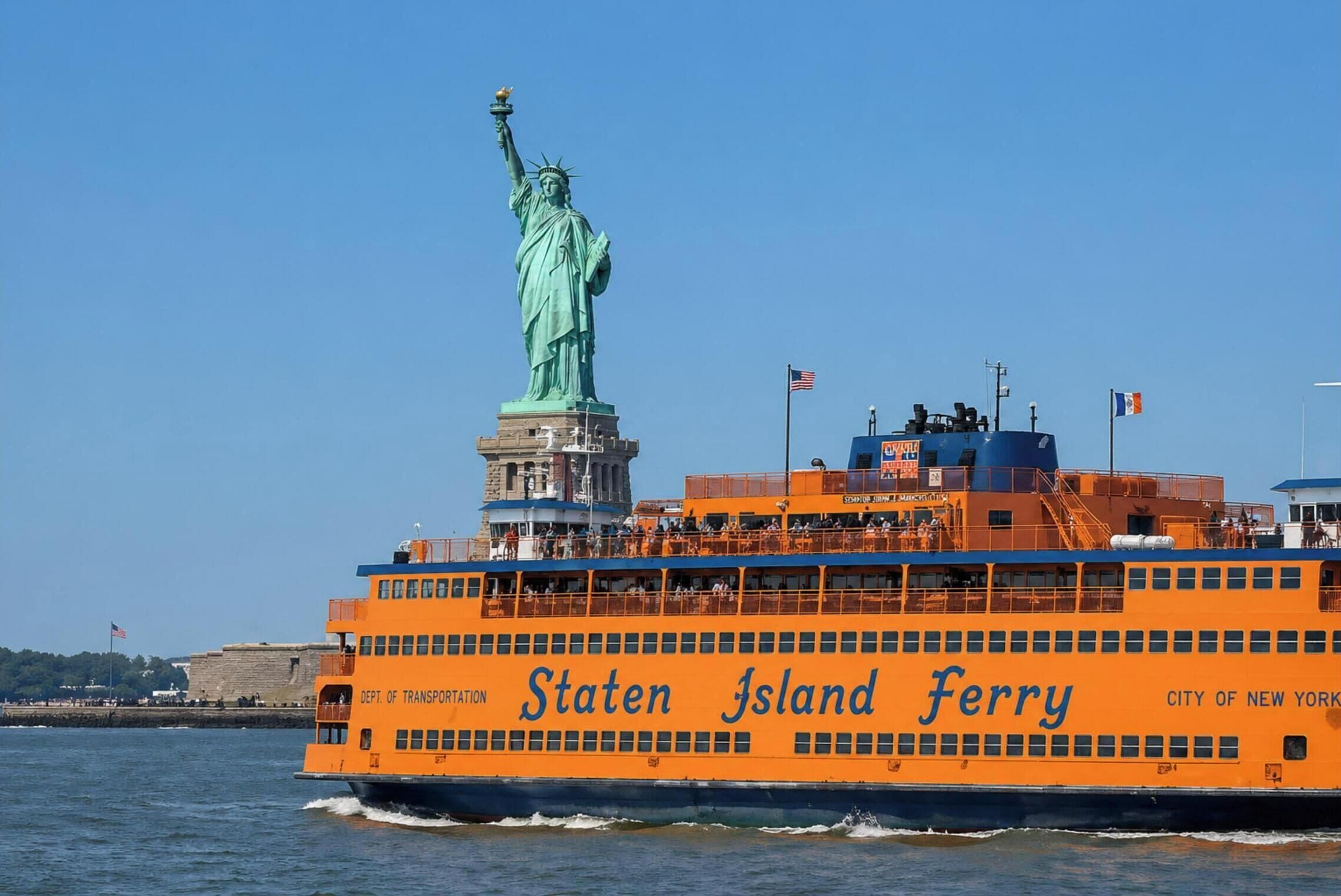 A ferry named Staten Island Ferry with the Statue of Liberty in the background.