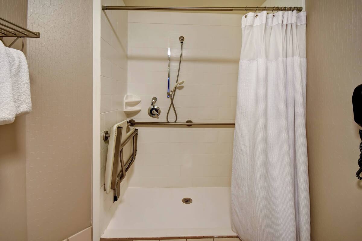 designer toiletries, hair dryer, towels