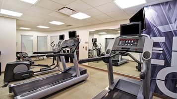A gym with treadmills, ellipticals, and a FlexDeck shock absorption system.