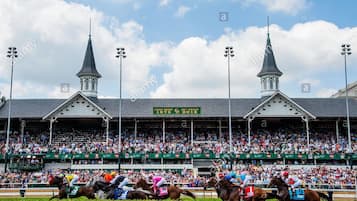 A horse racing track with a grandstand, two towers, and a sign indicating the event.
