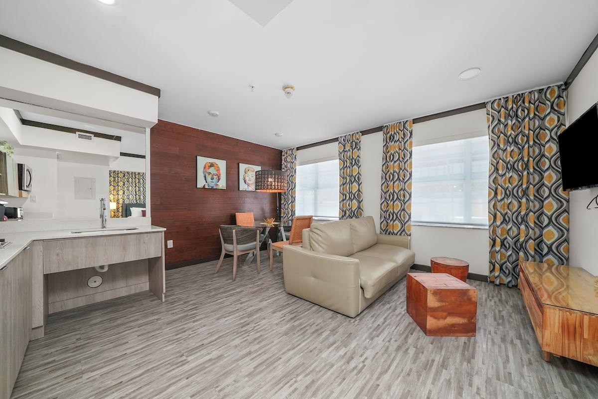 A modern living room with a sofa, a coffee table, and a TV.