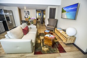 Suite, 2 Bedrooms | Living area | 42-inch plasma TV with cable channels, TV, iPod dock